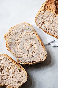 Slices of whole grain bread on a gray background. Close up