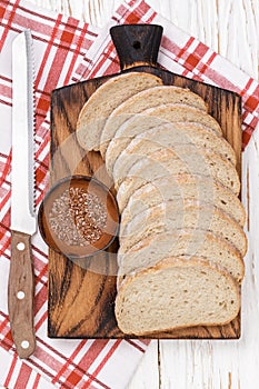 Slices of whole grain flax bread on chopping Board