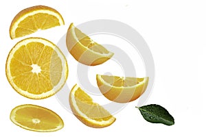 slices of yellow lemon lime fruit with green leaf isolated on white
