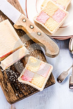 Slicing Battenberg homemade sponge cake