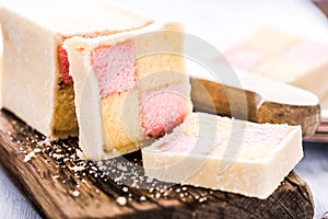 Slicing Battenberg homemade sponge cake