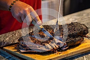 slicing a beef brisket fresh off of the smoker