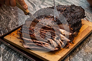 slicing a beef brisket fresh off of the smoker