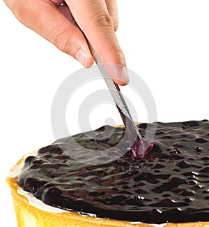 Slicing a blue berry cheese cake 1