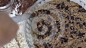 Slicing delicious and nutritious homemade oats banana breakfast bars with rich chocolate chunks, flax seeds and almonds