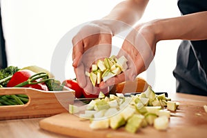 slicing fresh vegetables ingredients for salad healthy food in the kitchen