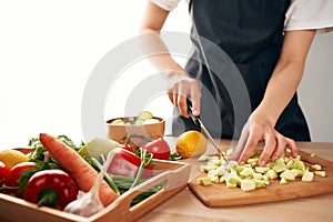 slicing fresh vegetables ingredients for salad healthy food in the kitchen