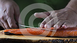Slicing gravlax salmon with a knife