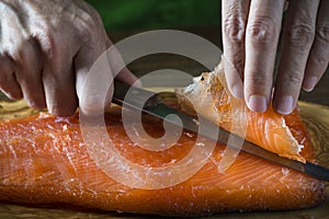 Slicing gravlax salmon with a knife photo