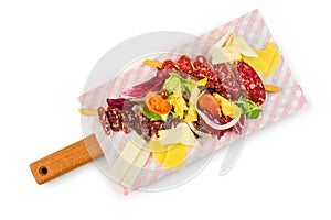 Slicing of meat, cheese and vegetables on cutting board on isolated background