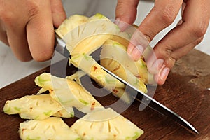 Slicing Pineapple on Wooden Chopping Board