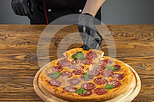 Slicing pizza on a wooden background for a restaurant menu7