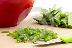 Slicing running beans on cutting board