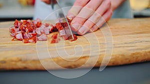 Slicing smoked sausages on a cutting board