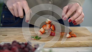 Slicing strawberry with knife