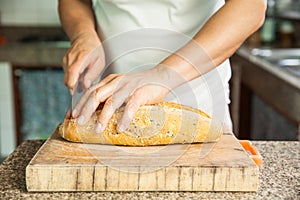 Slicing a whole grain bread with a knife