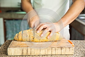 Slicing a whole grain bread with a knife