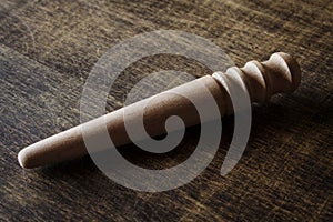 Slicker. Polishing tool. Brown table. Close-up.