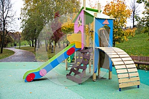 Slide children`s wooden blue yellow red color on the Playground in the city outdoors. Kids games sports