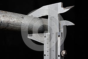 Slide gauge measuring a metal pipe