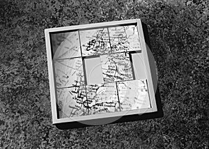 Slide-puzzle with jumbled map (b&w) photo