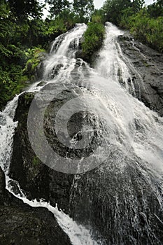 Slide Waterfall, also known as Catarata El Tobogan, tumles down in Viento Fresco, Costa Rica. photo