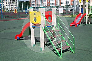 Slide wooden bright colors on the Playground with rubberized coating.