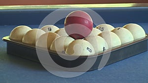 Slider shot of pool balls racked with cue ball ready