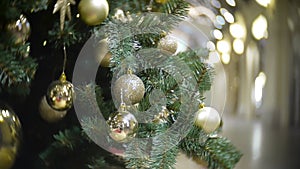 Slider view of golden mirror and matte balls. New Year`s and abstract blurred shopping mall background with Christmas