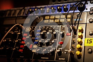 Sliders and knobs at an audio mixing console.