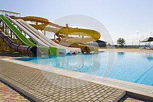 Slides near swimming pool  in water park