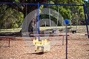 slides and swings in a playground in a park in australia in spring