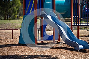 slides and swings in a playground in a park in australia in spring