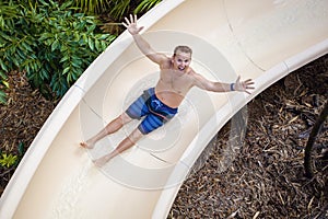 Sliding down a fun water slide at a waterpark photo