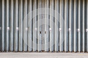 Sliding and folding industrial doors with No Smoking signs