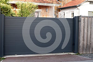 Sliding gate steel big grey metal portal fence on modern house street