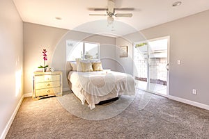 Sliding glass door allows warm light to flood this master bedroom in San Diego model home