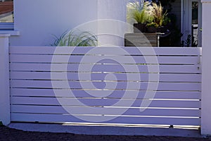 Sliding modern white gate aluminum portal with blades of suburban house garden access