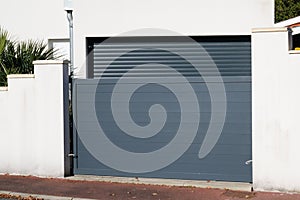 Sliding portal large metal gate grey fence on suburb street house door