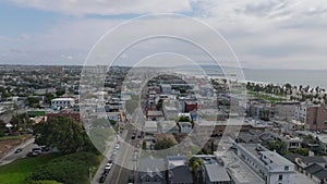 Sliding reveal of buildings in residential urban neighbourhood. Aerial view of houses near seacoast. Los Angeles