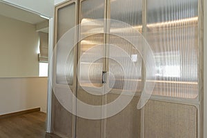 Sliding wooding doors of modern wardrobe in a hallway of a house.