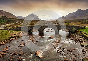 Sligachan old bridge on the Isle of Skye at beautiful sunset in Scotland. Nice landsape with river