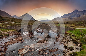 Sligachan old bridge on the Isle of Skye at beautiful sunset in Scotland. Nice landsape with river