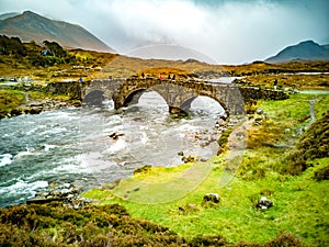 Sligachan Old stone Bridge over River Sligachan with Beinn Dearg Mhor and Marsco peak of Red Cuillin mountains in