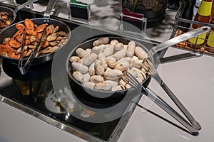 Slightly grilled Beef sausages in fry pan. Detail of buffet served in line at hotel