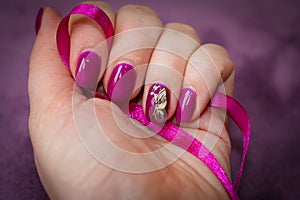 Slightly grown nails, covered with gel lacquer and decorated wit