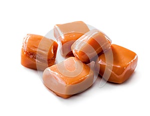 Slightly melted toffee caramel candy close-up isolated with clipping path on white photo