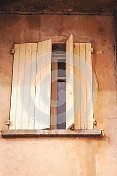 Slightly open, pair of, colorful, yellow, wood, window shutters, Seguret, France