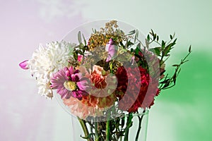 Slightly wilted flowers in a transparent vase