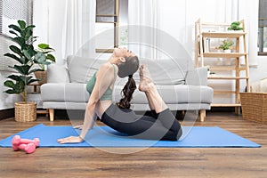 Slim Asian woman doing yoga meditation at home